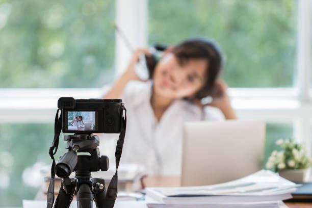 istock Happy Asian videoblog or student woman beauty blogger / vlogger recording tutorial coach presentation pass video for teaching live homework sharing online channel social media by mirrorless camera 1132372922