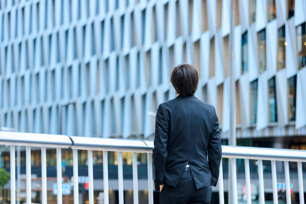 istock Buildings and suits behind a man 1132374820