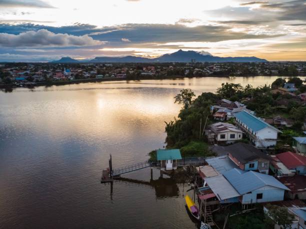 istock Sarawak River, Kuching, Malaysia at Sunset with Mount Serapi at the background 1132374834