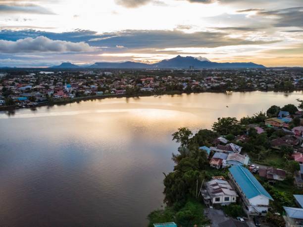 istock Sarawak River, Kuching, Malaysia at Sunset with Mount Serapi at the background 1132374897