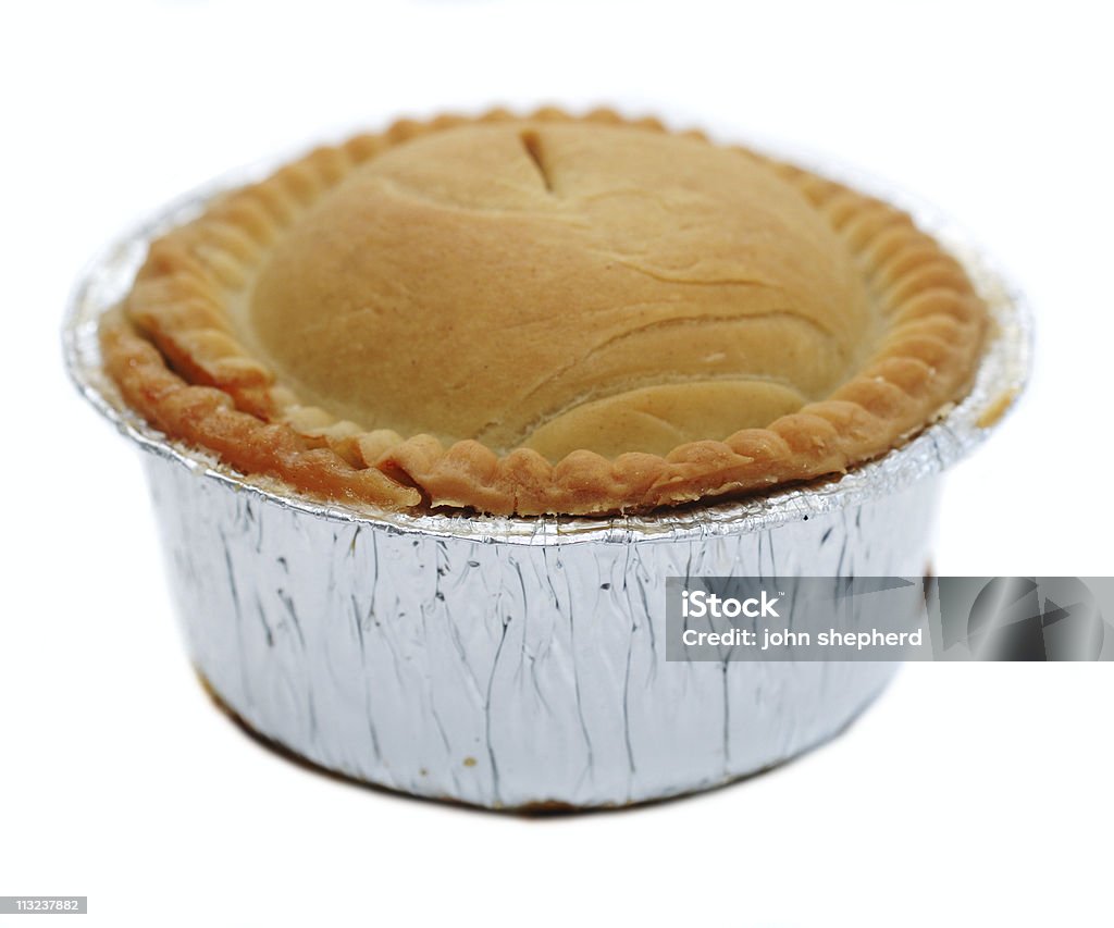 Meat pie in foil wrapper against white Color Image Stock Photo