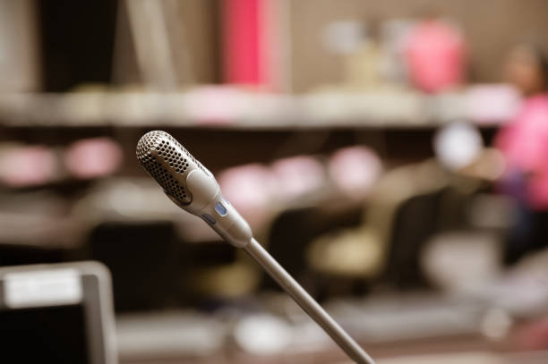 istock Microphone over the blurred business forum Meeting or Conference Training Learning Coaching Room Concept, Blurred background. 1132381580