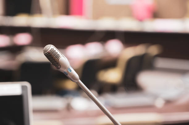 istock Microphone over the blurred business forum Meeting or Conference Training Learning Coaching Room Concept, Blurred background. 1132381584