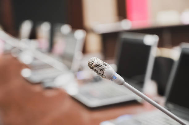 istock Microphone over the blurred business forum Meeting or Conference Training Learning Coaching Room Concept, Blurred background. 1132381590