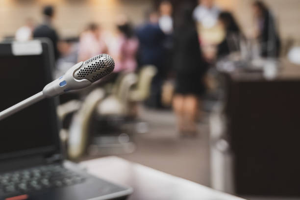 istock Microphone over the blurred business forum Meeting or Conference Training Learning Coaching Room Concept, Blurred background. 1132381685