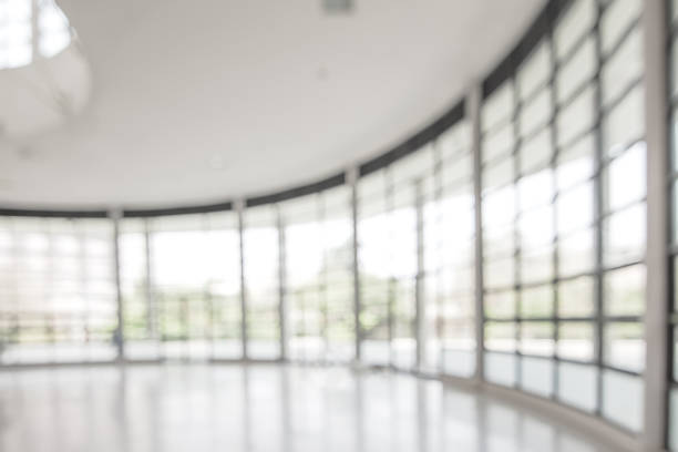 istock Blur background interior view looking out toward to empty office lobby and entrance doors and glass curtain wall 1132381724