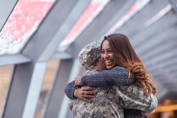istock Woman hugging her partner after returning home from service 1132382298