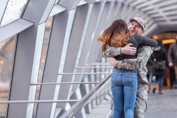 istock Woman hugging her partner after returning home from service 1132382299