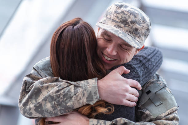 istock Man hugging his wife after returning home from service 1132382300