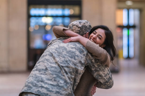 istock Woman hugging her partner after returning home from service 1132382301