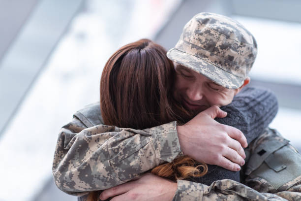 istock Man hugging his wife after returning home from service 1132382302