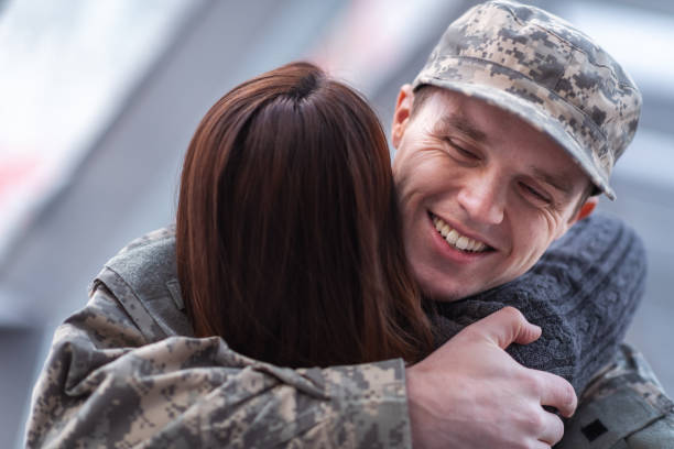 istock Man hugging his wife after returning home from service 1132382307