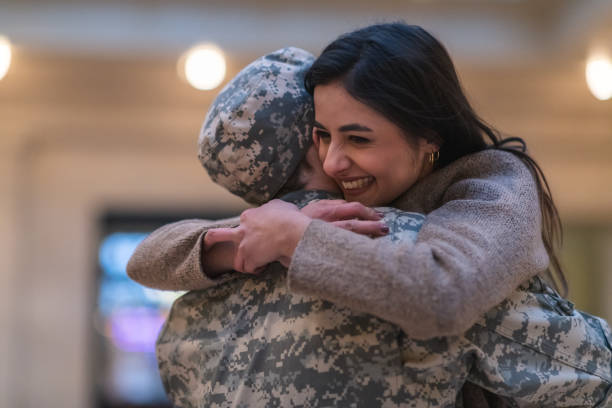istock Woman hugging her husband after returning home from service 1132382310