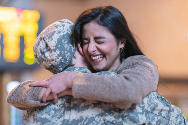 istock Woman hugging her husband after returning home from service 1132382315