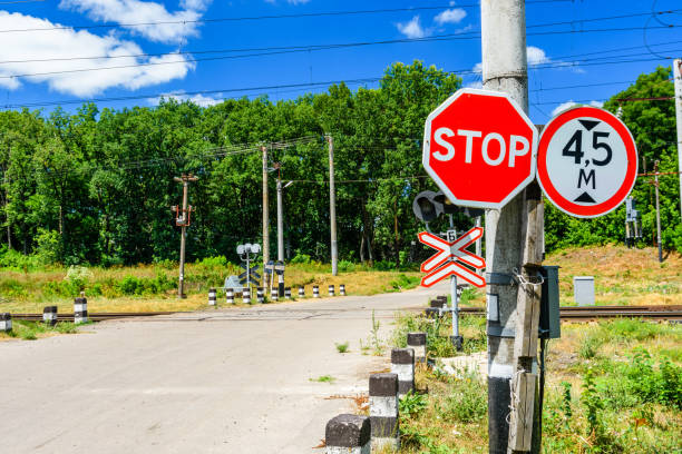 stop sign in front of the railroad crossing - railroad crossing railway signal gate nobody imagens e fotografias de stock