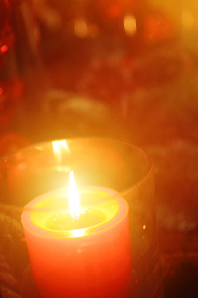 istock Christmas Candle Fire in Front of Christmas Tree 1132391221
