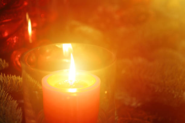 Tea light with colorful light bokeh in the background, Candle is ion the left side.