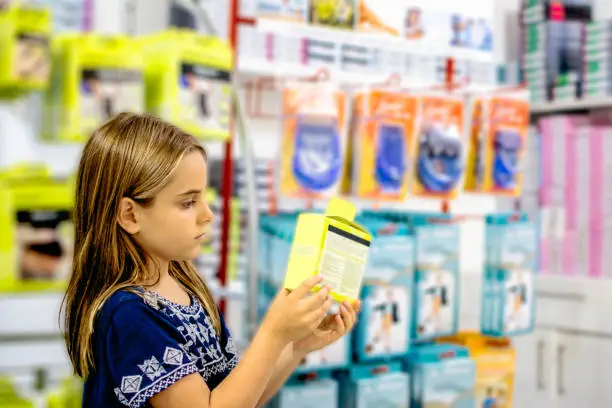 Child girl looking for products in store