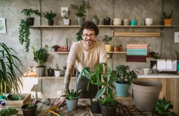 Portrait of Happy Florist Man Working at His Flower Shop