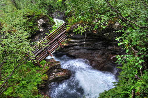 The bewitching beauty of the Caucasus Mountains with lush vegetation, with a gorge between the peaks of the mountains, a road laid there and clouds sleeping on the tops of the mountains. Abkhazia