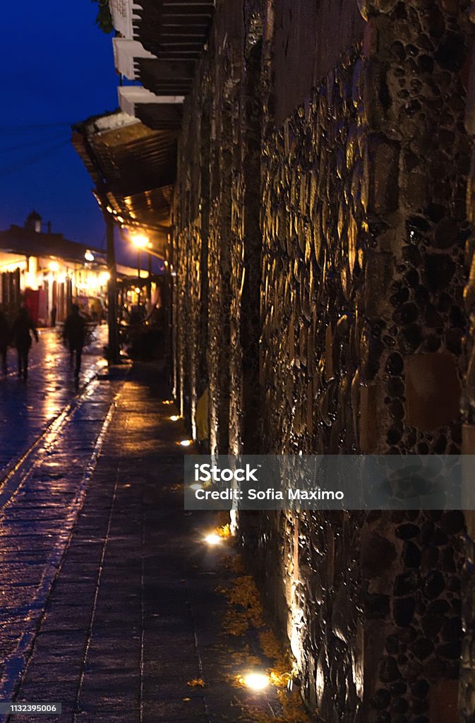 Perspective of the illuminated stone wall in the old town, on a rainy day, from the city called Xico of the state of Veracruz, Mexico, at night with window and antique lighting. 16/11/18 SONY DSC Architecture Stock Photo