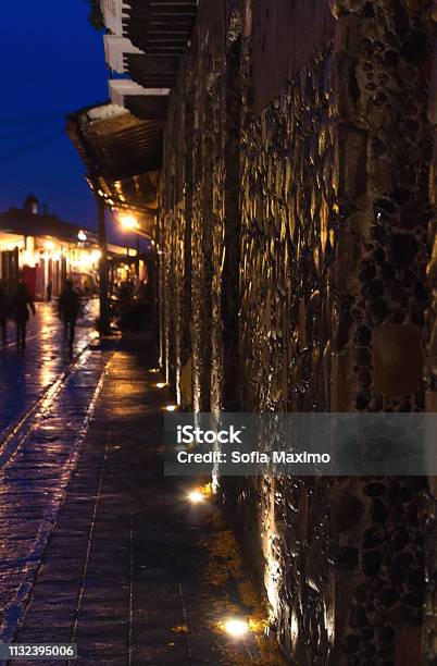 Perspective Of The Illuminated Stone Wall In The Old Town On A Rainy Day From The City Called Xico Of The State Of Veracruz Mexico At Night With Window And Antique Lighting 161118 Stock Photo - Download Image Now