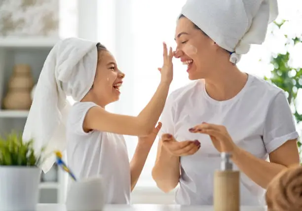 Photo of Mother and daughter caring for skin