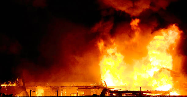 istock View aerial photo House fire burns during night time 1132404728