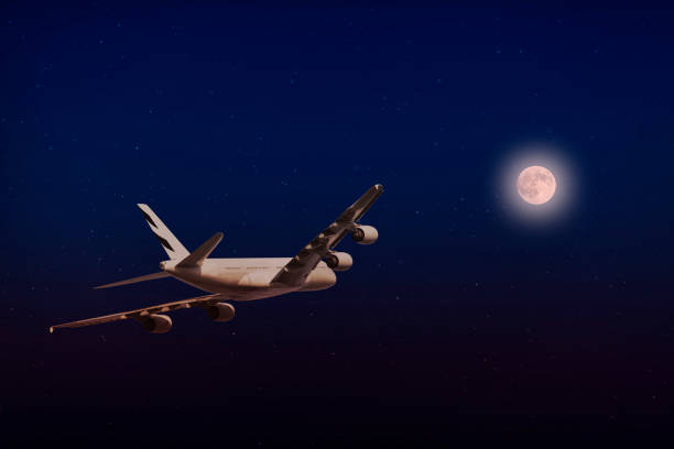 istock A plane flying towards a beautiful moonlight 1132404881
