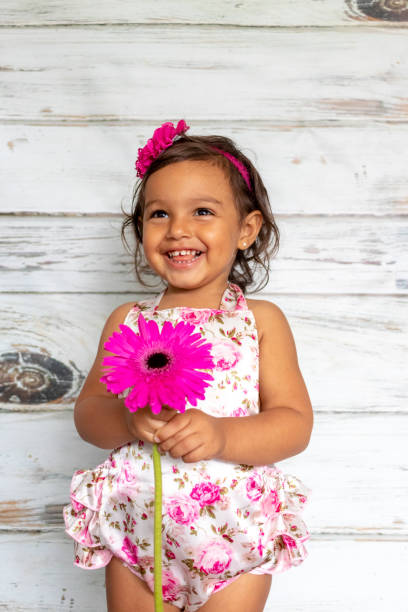 istock Tender smiling toddler, with a flower in her hand 1132407927