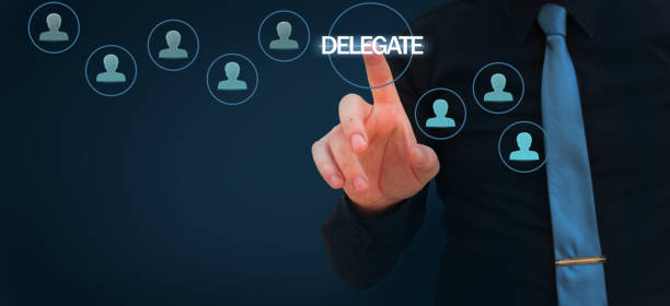 istock Businessman pointing finger to delegate word on virtual screen 1132408074