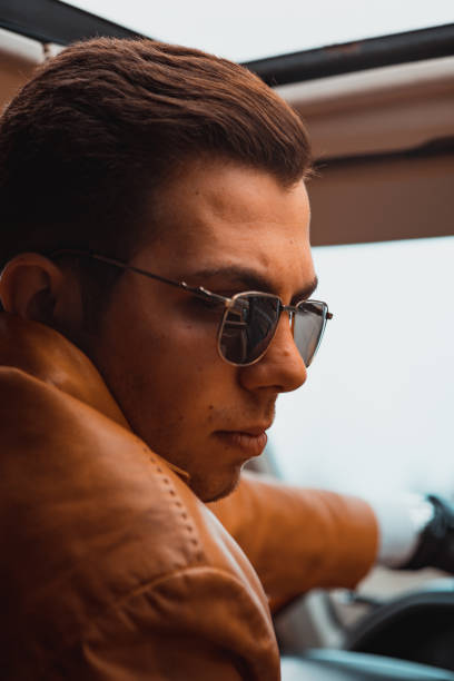 istock Young business man in car interior close-up 1132409814