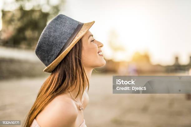Happy Young Hipster Woman Day Dreaming On A Beautiful Sunset In The City Stock Photo - Download Image Now