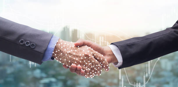istock close up business man handshake with business robot virtual interface hologram connect of artificial intelligence (AI) on motion blur city metropolis background with double exposure of stock trading board and for future technology concept 1132415712
