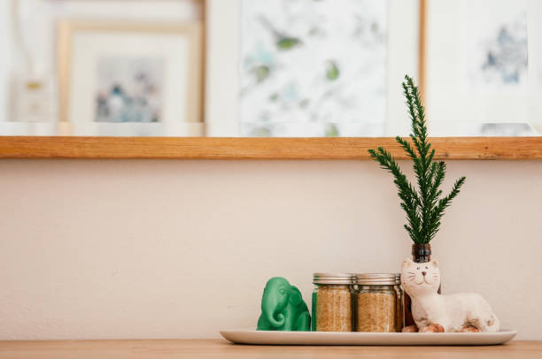 istock Ceramic cat and elephant figures with pine leaf and brawn sugar bottles on wood counter 1132415949