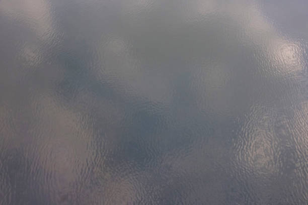 istock Blurred reflection of clouds on the surface of the water with light ripples. 1132416162