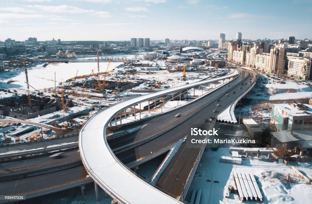 drone panoramic view of Chelyabinsk snow cityscape Aerial drone view of construction site; cranes and machines; new segment of road junction; development of modern infrastructure in Chelyabinsk; panoramic cityscape; Shanghai cooperation organization High Angle View Stock Photo
