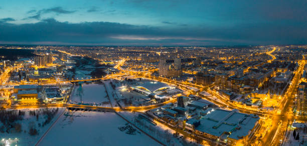 drone panoramic view of Chelyabinsk snow cityscape Aerial drone panorama; beautiful view Chelyabinsk city with illuminated streets and bridges at night; winter evening South Ural capital; industrial and pollution problem; undeveloped urban environment shanghai cooperation organization stock pictures, royalty-free photos & images