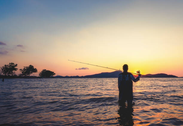 istock Young man fishing on a lake. 1132419249