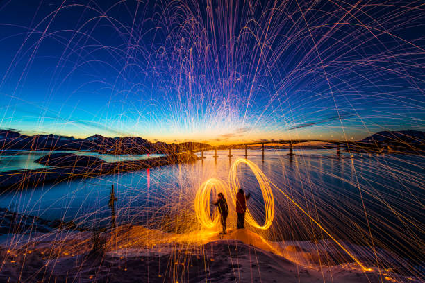 Sommaroy light painting Northern Norway Spectacular sunset Sommaroy Island light painting sparks spinning Northern Norway Scandinavian winter landscape Europe sommaroy stock pictures, royalty-free photos & images