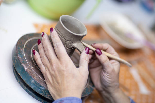 istock Hands of artist who make a mug from ceramic clay in studio 1132423257
