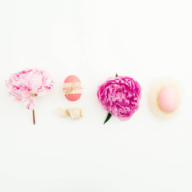 istock Ester festive composition with eggs, pink peonies flowers on white background. Flat lay, top view. 1132424390
