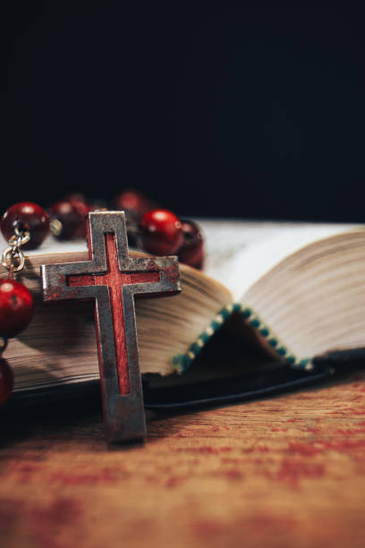 istock Old red Beads and crucifix on a Holy Bible background. Macro view. 1132425829