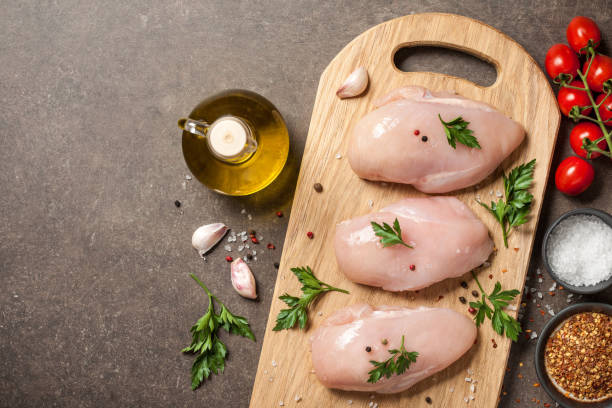 istock Fresh raw chicken fillets with ingredients for cooking 1132426848