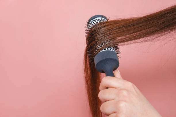 istock comb for hair volume in female hand 1132428163