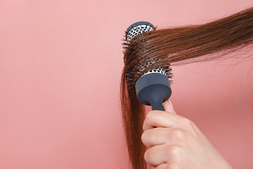 comb for hair volume in female hand