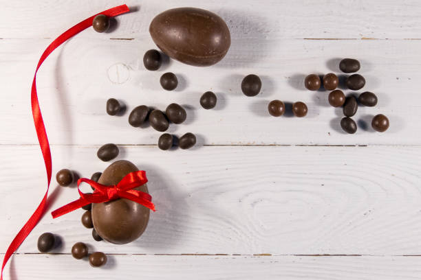 istock Easter composition with chocolate eggs on white wooden background 1132429066