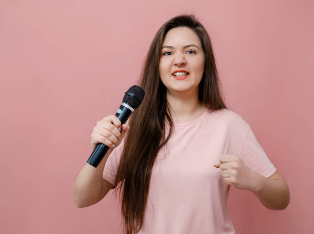 istock young protest woman with microphone in hand  on pink background 1132430313