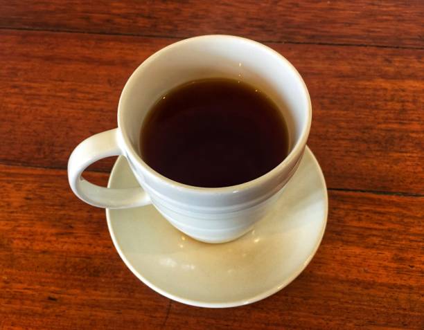 istock white cup of tea on a wooden table background 1132430643