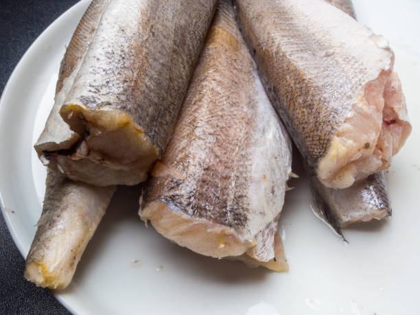 istock raw fish hake isolated on white plate 1132430788